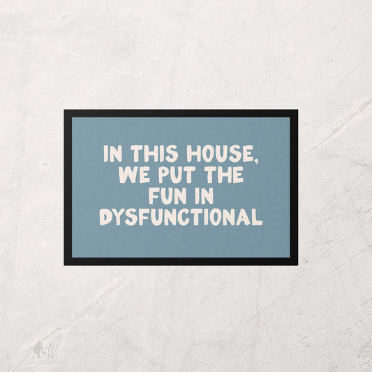 Framed poster with text 'In this house, we put the fun in dysfunctional' on a light gray background
